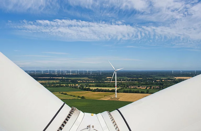 Blick von einer Windenergieanlage über eine Landschaft mit weiteren Windrädern